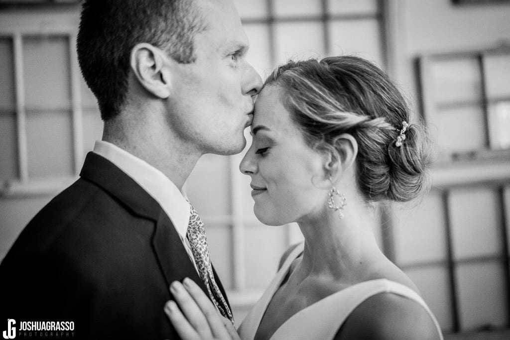 Bride and groom kiss portrait at Monday Night Garage Wedding