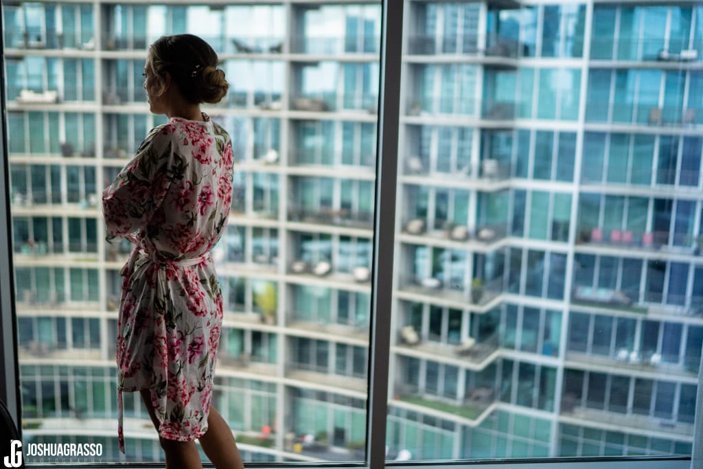 Bride overlooking skyline getting ready at Loews hotel in atlanta