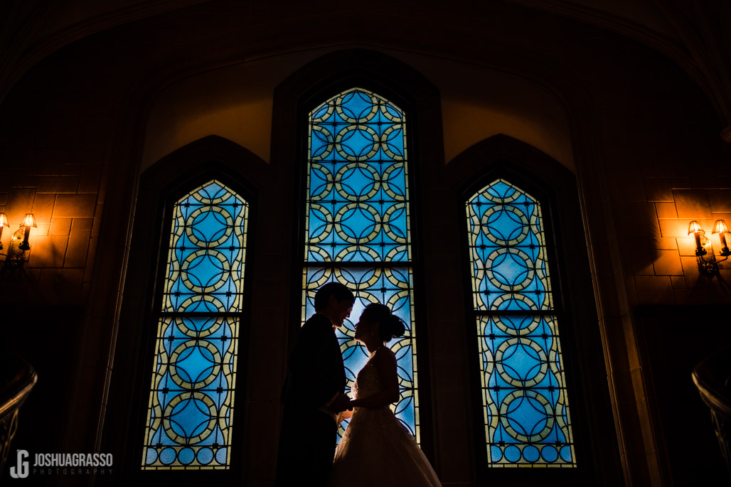 Bride and Groom portrait in front stain-glass window at callanwolde fine arts center.