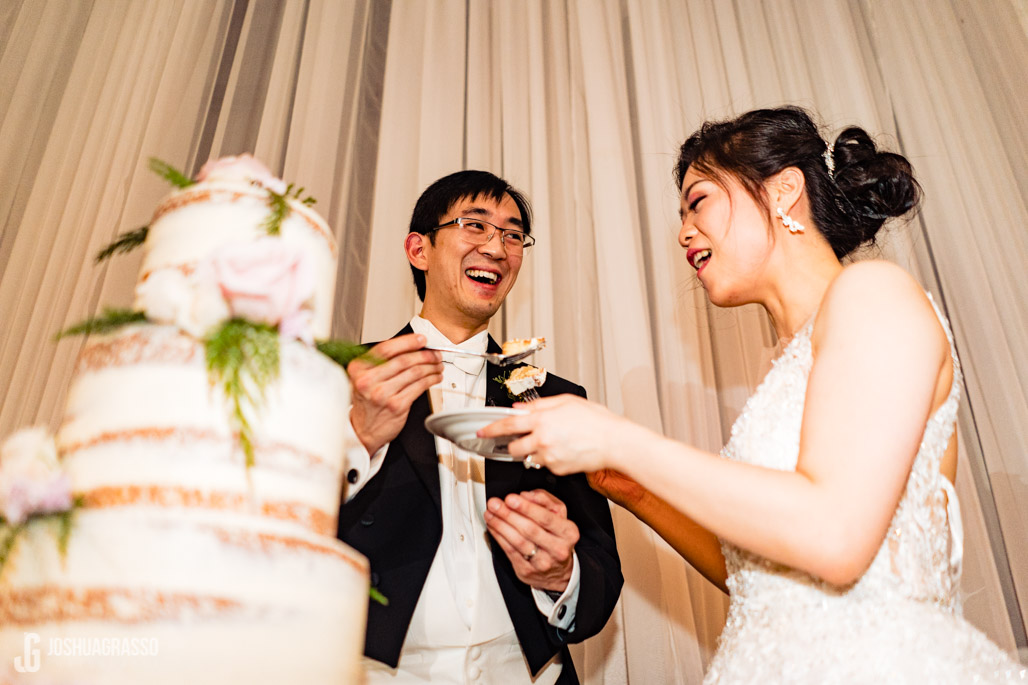 Bride and Groom Enjoying their wedding cake at the reception at Callanwolde fine art center.