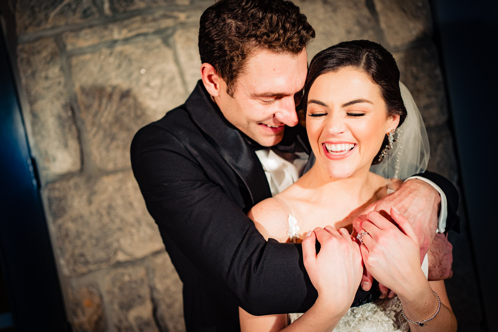 Couple laughs during portraits at greystone wedding.