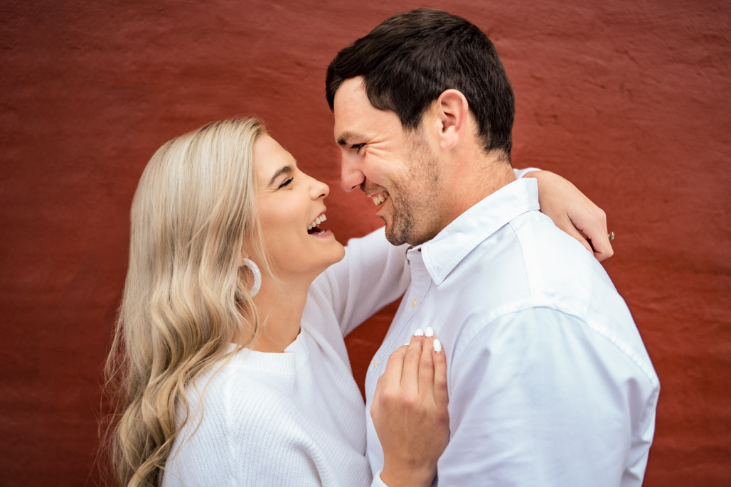 Couple laughing during an engagement session in downtown ball ground georgia